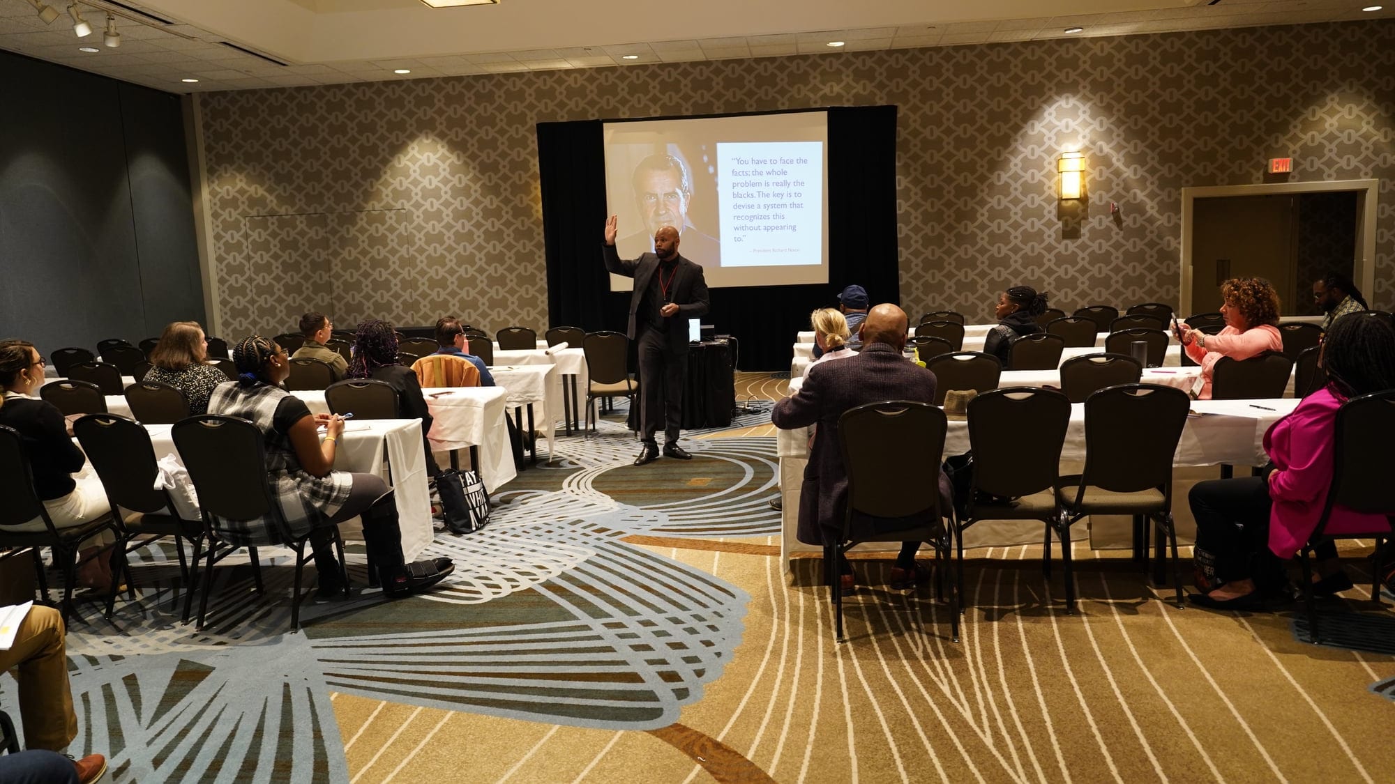 Legal professionals seated at tables during an accredited continuing education session led by Dante King.